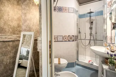 a bathroom with a shower and a toilet and a sink at Santamaria Inn in Rome