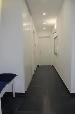 a hallway with a white door and a black floor at Ma Belle Maison in Rome