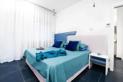 a bedroom with a bed with a blue comforter at Ma Belle Maison in Rome