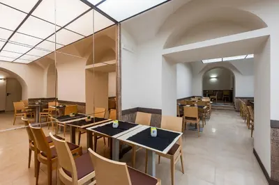 a dining room with tables and chairs at Hotel California in Rome