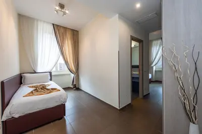 a bedroom with a bed and a large window at Hotel California in Rome