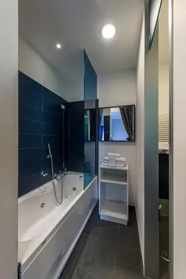 a bathroom with a tub and a shower and a sink at Hotel California in Rome