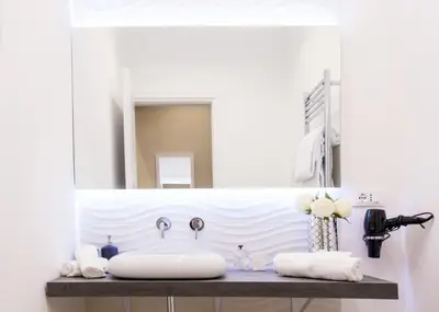 a bathroom with a sink and a mirror at Nazionale Palace Suites in Rome