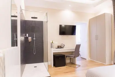 a bathroom with a desk and a shower with a computer at Nazionale Palace Suites in Rome