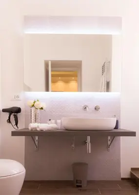 a bathroom with a sink and a mirror at Nazionale Palace Suites in Rome