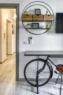 a bike in a room with a table and a mirror at Grand Sapienza Apartment by RHR in Rome