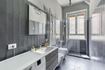 a bathroom with a tub and a toilet and a sink at Grand Sapienza Apartment by RHR in Rome