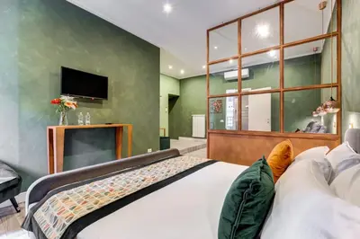 a bedroom with a large bed and a flat screen tv at Ripetta Luxurious Suites in Rome