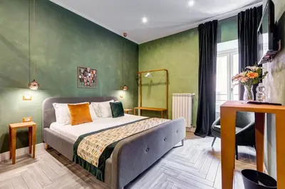 a bedroom with a bed and green walls at Ripetta Luxurious Suites in Rome