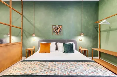 a bedroom with a bed with colorful pillows at Ripetta Luxurious Suites in Rome