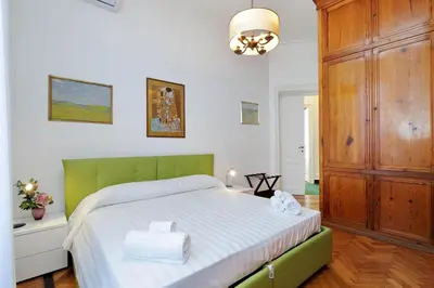 a bedroom with a large bed with towels on it at Prestigious Apartment Via Veneto in Rome