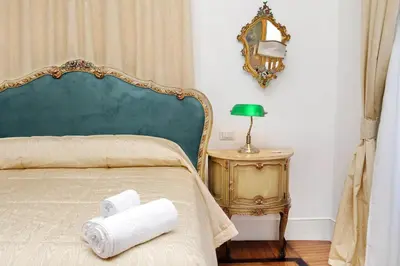 a bedroom with a bed with two rolled towels on it at Prestigious Apartment Via Veneto in Rome