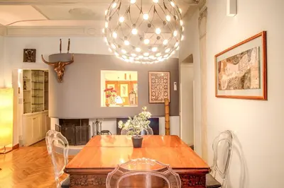 a dining room with a table and a chandelier at Governo Vecchio in Rome