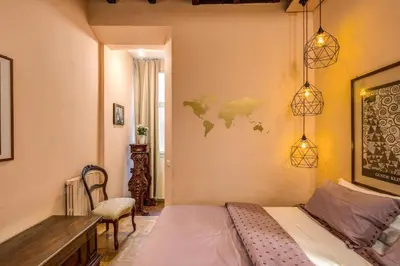 a bedroom with a bed and a desk and a map on the wall at Governo Vecchio in Rome