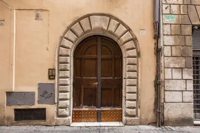 a large wooden door on the side of a building at Governo Vecchio in Rome