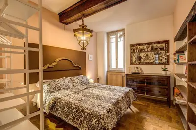 a bedroom with a bed and a ladder at Governo Vecchio in Rome