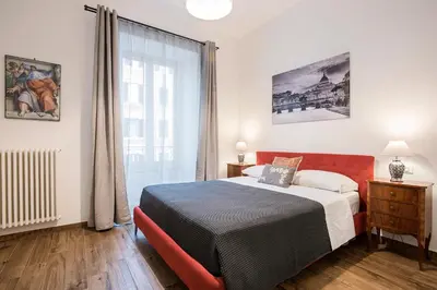 a bedroom with a bed and a large window at Vatican Scipioni 113 in Rome