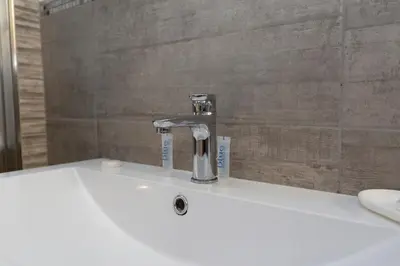 a bathroom sink with a faucet on top of it at Vatican Scipioni 113 in Rome
