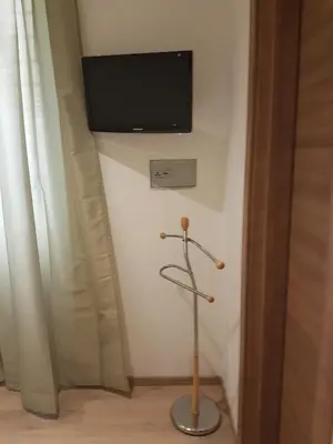 a television on a wall in a room at Ponte della musica Teatro Olimpico in Rome