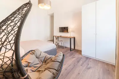 a room with a bed and a hanging chair at Guest Roma House in Rome
