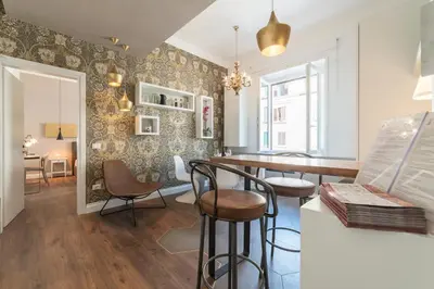 a living room with a bar and chairs and a table at Guest Roma House in Rome