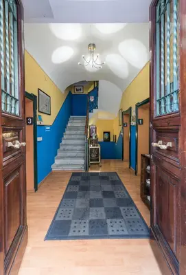 a hallway with blue and yellow walls and stairs at A Roma San Pietro Best Bed in Rome