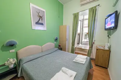 a bedroom with a bed and a television in it at A Roma San Pietro Best Bed in Rome