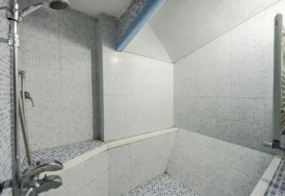 a bathroom with a shower with white tiles at A Roma San Pietro Best Bed in Rome