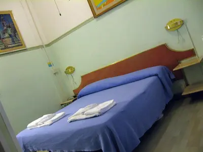 a hospital room with a bed with towels on it at A Roma San Pietro Best Bed in Rome