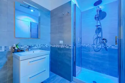 a bathroom with a sink and a shower at DIDAVI' Guest House in Rome