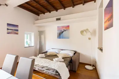 a living room with a bed and a table and chairs at The Hide Trastevere in Rome