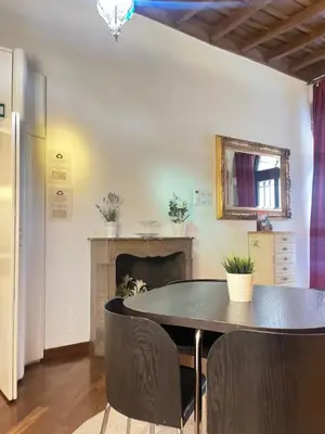 a dining room with a table and a fireplace at The Ancient Wall in Rome
