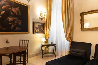 a living room with a table and a painting on the wall at Boccaccio 22 in Rome