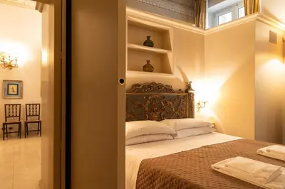 a bedroom with a bed and a window with shelves at Boccaccio 22 in Rome