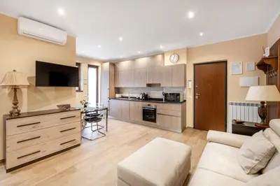 a living room with a couch and a kitchen at ROMAN DREAM II in Rome
