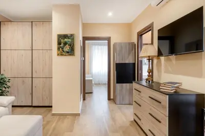 a living room with a dresser and a tv at ROMAN DREAM II in Rome