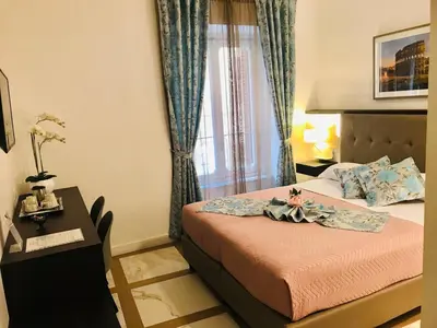 a hotel room with a bed and a window at KAMBAL LUXURY SUITES in Rome