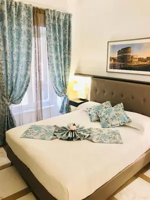 a bed with blue curtains and a bow on it at KAMBAL LUXURY SUITES in Rome