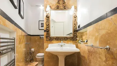 a bathroom with a sink and a mirror on the wall at Nobildonne Relais in Rome