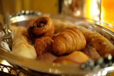 a bunch of different types of pastries in a glass plate at Nobildonne Relais in Rome