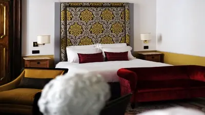 a hotel room with a bed and a couch at Nobildonne Relais in Rome