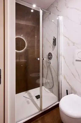 a shower with a glass door in a bathroom at DEM Hotel in Rome