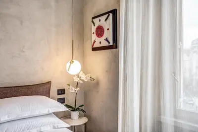 a bedroom with a bed and a clock on the wall at G55 Design Hotel in Rome