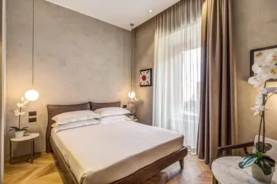 a bedroom with a large bed and a window at G55 Design Hotel in Rome