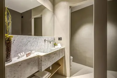a bathroom with a sink and a mirror at G55 Design Hotel in Rome