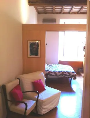 a living room with two beds and a chair at Piazza Argentina/Pantheon in Rome