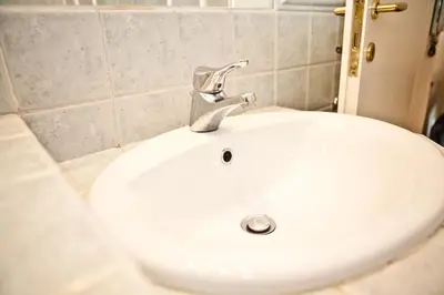 a white sink with a faucet in a bathroom at Piazza Argentina/Pantheon in Rome