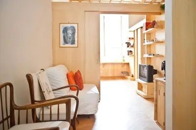 a living room with a bed and a television at Piazza Argentina/Pantheon in Rome