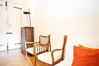 a living room with two chairs and a couch at Piazza Argentina/Pantheon in Rome