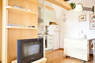 a living room with a tv and a kitchen at Piazza Argentina/Pantheon in Rome